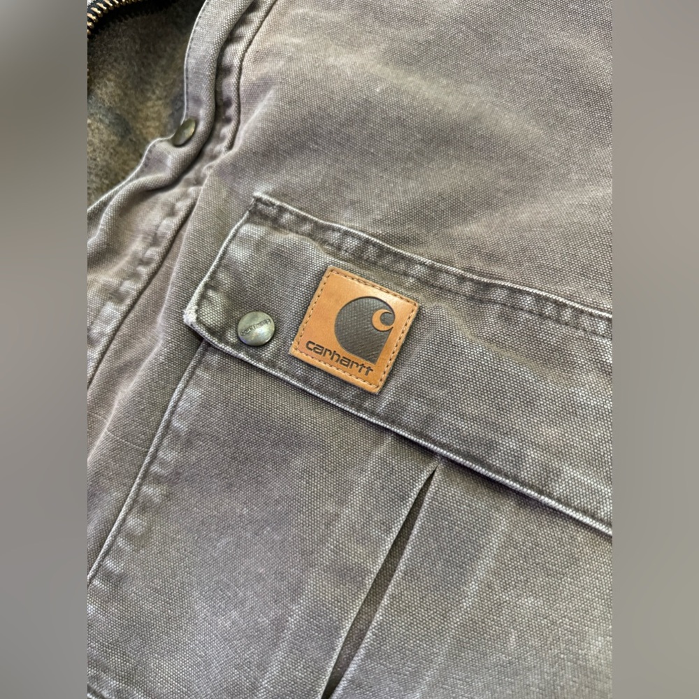Vintage Carhartt utility jacket with embroidered logo.